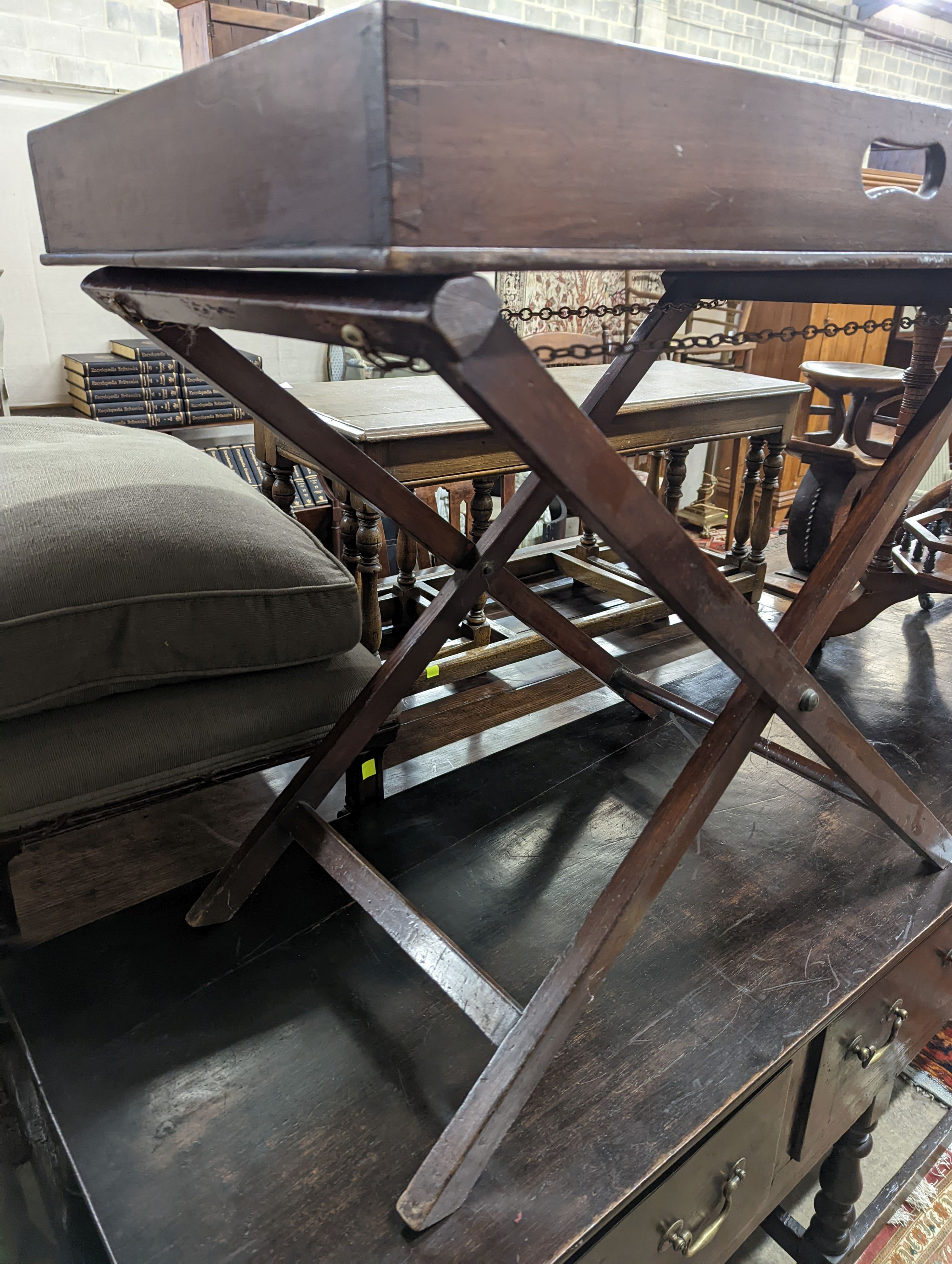 A 19th century rectangular mahogany butler's tray on folding stand, width 24cm, depth 49cm, height 71cm